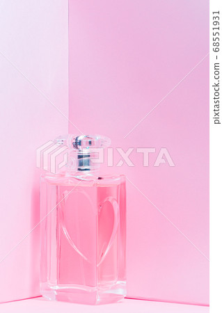 pink perfume bottle on pink background copy space. bot view, vertical orientation pink perfume bottle on pink background copy space. bot view, vertical orientation 68551931