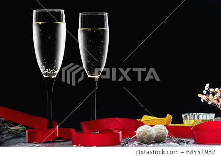 Two glasses of champagne with a red ribbon on a dark background, copy Two glasses of champagne with a red ribbon on a dark background, copy 68551932