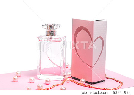 pink perfume bottle with pearls and a gold chain and a box on a pink sheet on a white background copy space. bot view, mockup pink perfume bottle with pearls and a gold chain and a box on a pink sheet on a white background copy space. bot view, mockup 68551934