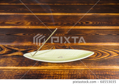 incense sticks on a wooden background isolate 68553035