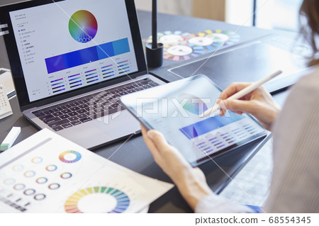 Woman designing on a tablet 68554345