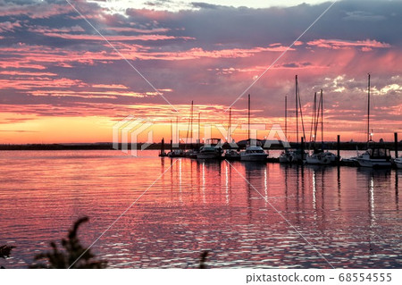 A beach bathed in sunset light 68554555