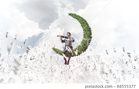 Handsome businessman play his melody and symbols fly around in air 68555377