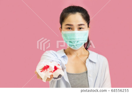 Young asian woman wore a gray undershirt, Blue shirt and protective masks against virus and air pollution,hand holding red heart, isolated on pink background,health care concept Young asian woman wore a gray undershirt, Blue shirt and protective masks against virus and air pollution,hand holding red heart, isolated on pink background,health care concept 68556255