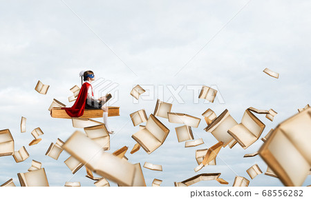 Girl power concept with cute kid guardian against cloudscape background Girl power concept with cute kid guardian against cloudscape background 68556282