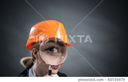 Technical inspector looking through magnifier Technical inspector looking through magnifier 68556979
