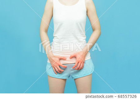 woman in white clothes put her hands on the genitalia area,hand on spot of ache and red mark, Penis pain or Itching urinary Health-care concept on blue background woman in white clothes put her hands on the genitalia area,hand on spot of ache and red mark, Penis pain or Itching urinary Health-care concept on blue background 68557326