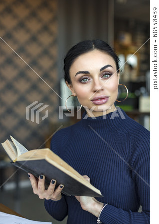 Portrait of female teacher holding book Portrait of female teacher holding book 68558439