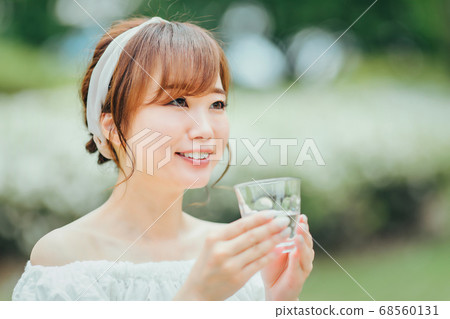 A woman drinking water A woman drinking water 68560131
