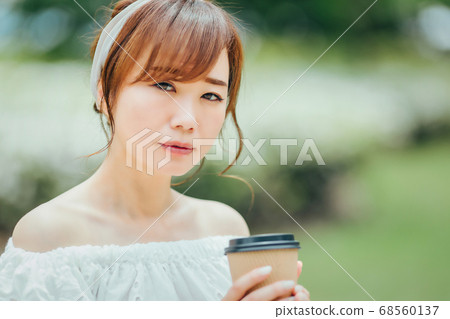 A woman drinking hot drinks A woman drinking hot drinks 68560137