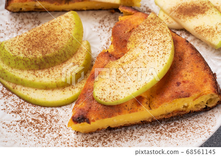 Cottage cheese casserole with apples and cinnamon spices. Concept of a healthy Breakfast. Close up Cottage cheese casserole with apples and cinnamon spices. Concept of a healthy Breakfast. Close up 68561145