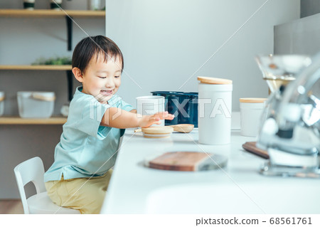 A little boy is smiling and cooking in the kitchen kids cooking 68561761