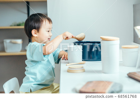 A little boy is smiling and cooking in the kitchen kids cooking A little boy is smiling and cooking in the kitchen kids cooking 68561768