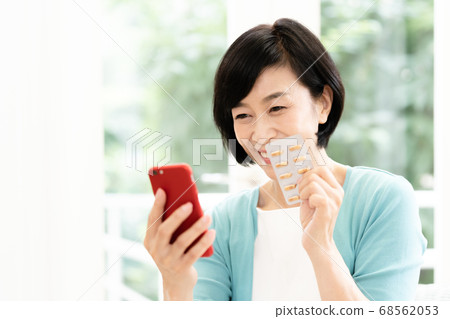 Middle woman looking at smartphone and drug 68562053