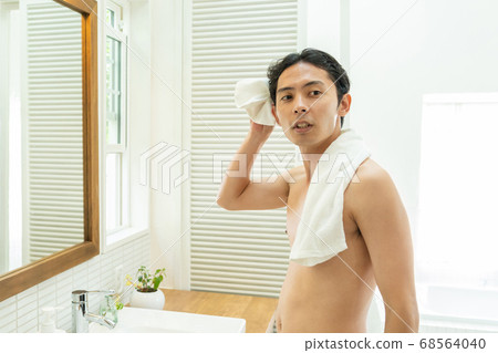 A young man taking a bath A young man taking a bath 68564040