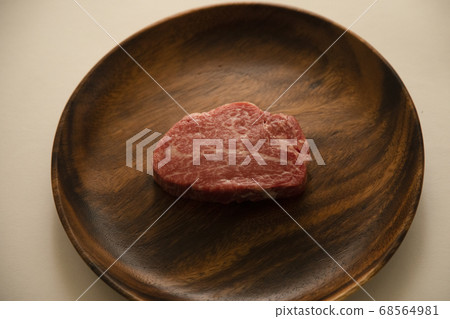 Raw thick beef fillet steak on acacia plate Raw thick beef fillet steak on acacia plate 68564981