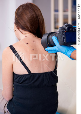 Young woman visiting male doctor dermatologist Young woman visiting male doctor dermatologist 68565516