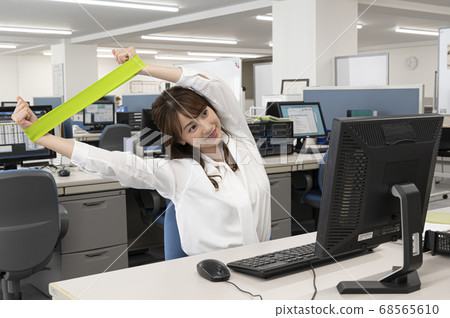 Young woman stretching during work Young woman stretching during work 68565610