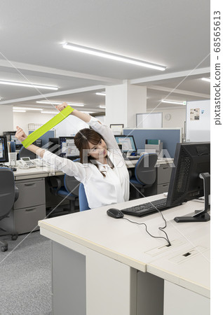 Young woman stretching during work Young woman stretching during work 68565613