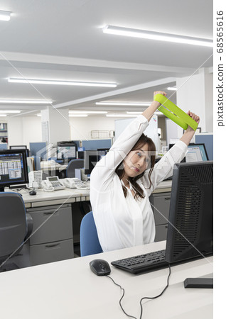 Young woman stretching during work Young woman stretching during work 68565616