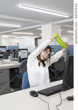 Young woman stretching during work Young woman stretching during work 68565618