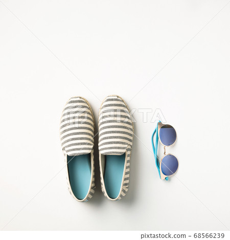 Summer vacation concept flat lay. Summer shoes and sunglasses, top view. Summer vacation concept flat lay. Summer shoes and sunglasses, top view. 68566239