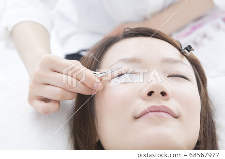 A woman with eyelash extensions 68567977