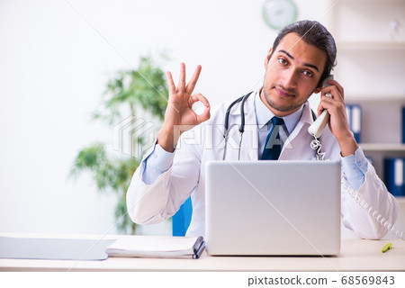 Young male handsome doctor working in the clinic 68569843