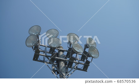 Looking up at the large soccer ground lighting from the bottom left 68570536