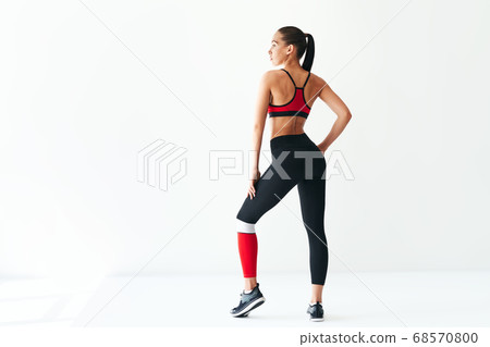 Back view of young woman in sportswear on white background with copy space 68570800