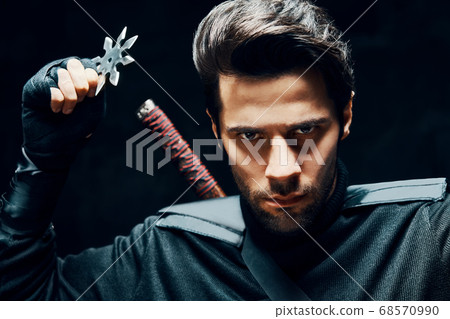 Warrior fighter with a sword and shuriken ready to stab enemy Warrior fighter with a sword and shuriken ready to stab enemy 68570990