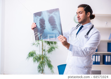 Young male handsome doctor working in the clinic 68571024