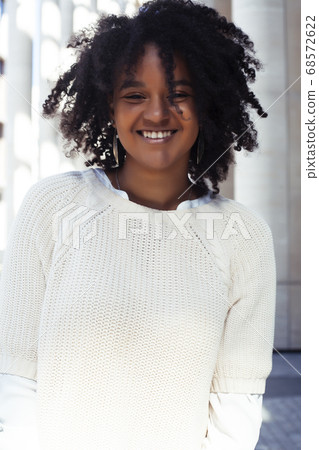 young pretty african girl posing cheerful on city background, lifestyle outdoor people concept young pretty african girl posing cheerful on city background, lifestyle outdoor people concept 68572622