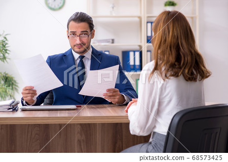 Business meeting between businessman and businesswoman 68573425