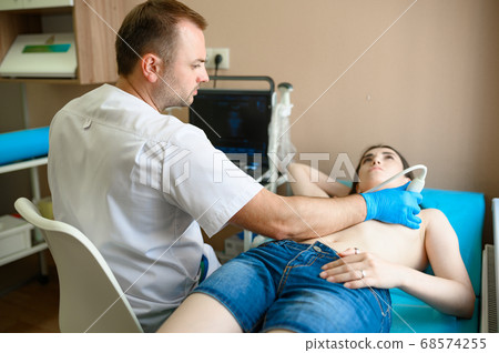 A mammologist makes breast ultrasound scanning 68574255