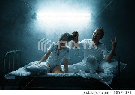 Psycho man torments woman in bed, psychedelic Psycho man torments woman in bed, psychedelic 68574371