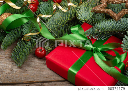 Christmas gift and fir branches Christmas gift and fir branches 68574379