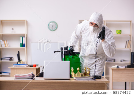 Contractor disinfecting office for COVID-19 coronavirus 68574432