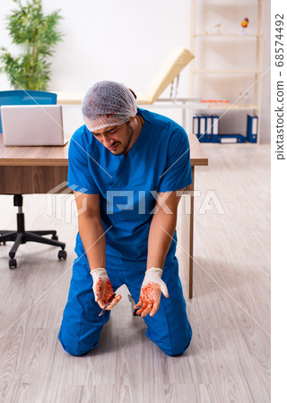 Young male doctor surgeon in fatal negligence concept 68574492