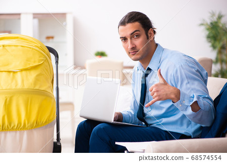 Young businessman looking after newborn at home Young businessman looking after newborn at home 68574554