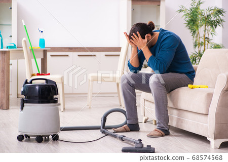 Young man husband doing housework at home Young man husband doing housework at home 68574568