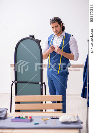 Young male tailor working at workshop 68575358