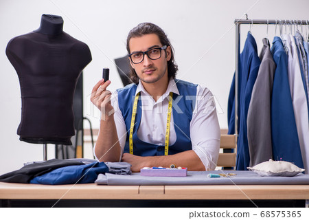 Young male tailor working at workshop 68575365