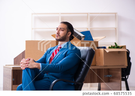 Young male employee in relocation concept Young male employee in relocation concept 68575535