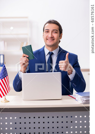 Young man checking passport at USA embassy Young man checking passport at USA embassy 68576161