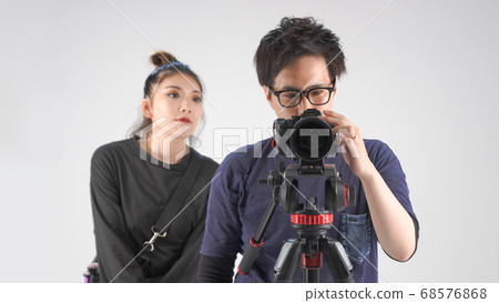 Photographer and make-up artist checking the video 68576868