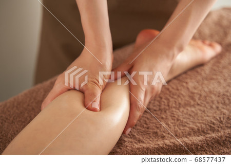 Japanese woman receiving foot massage at an esthetic salon 68577437