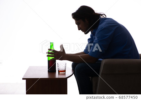 Young man suffering from alcoholism 68577450
