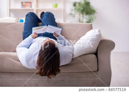 Young male student preparing for exams at home 68577519