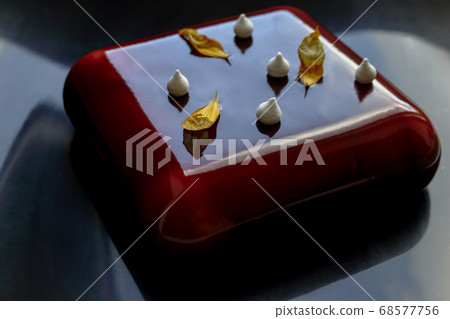 Square chocolate cake with yellow sunflower petals and little meringue kisses 68577756
